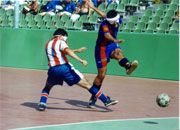 Two athletes are struggling for the claim of the ball during a Football 5-a-side game.
