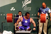 Nick Slater of Great Britain in action whilst winning bronze during the Powerlifting 100 kg division at the 2000 Paralympic Games. © Scott Barbour/Allsport